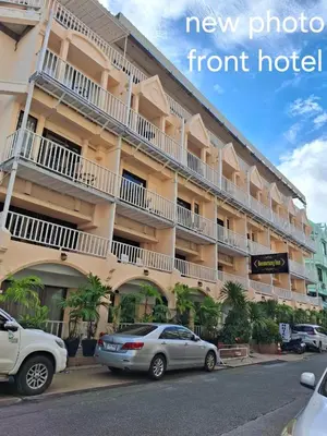 a building with two cars parked in front of it at Boomerang Inn in Patong Beach