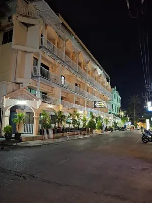 an empty street in front of a building at night at Boomerang Inn in Patong Beach