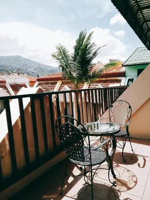 a table and chairs on a balcony with a view at Boomerang Inn in Patong Beach