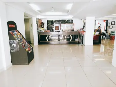 a restaurant with a counter in the middle of a room at Boomerang Inn in Patong Beach