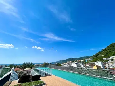 a view from the balcony of a building with a swimming pool at The Deck Patong by VIP in Patong Beach