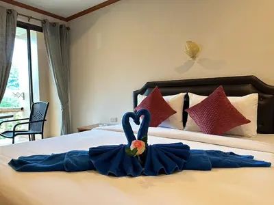 a bed with a flower made out of blue sheets at Mala Hotel in Kata Beach