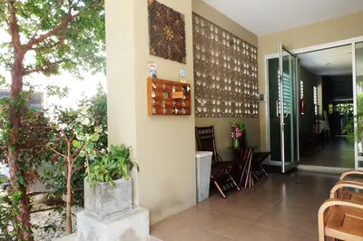 a lobby of a restaurant with tables and chairs at Benjamas Place Hotel in Rawai Beach