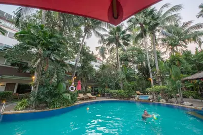 a man in the pool at the hotel at The Viridian Resort Patong in Patong Beach