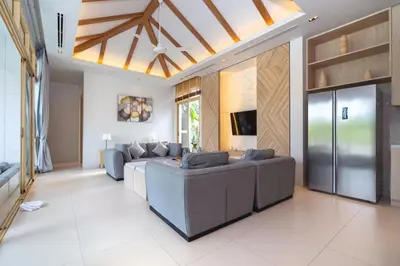 a large living room with couches and a ceiling at Himmapana Villas - SHA Extra Plus in Kamala Beach