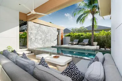 an outdoor patio with a couch and a table at Himmapana Villas - SHA Extra Plus in Kamala Beach