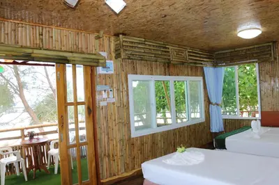 a room with two beds and two windows at Ruan Mai Naiyang Beach Resort in Nai Yang Beach