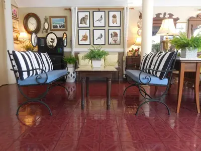 a living room with two chairs and a table at Holiday Village And Natural Garden Resort in Karon Beach