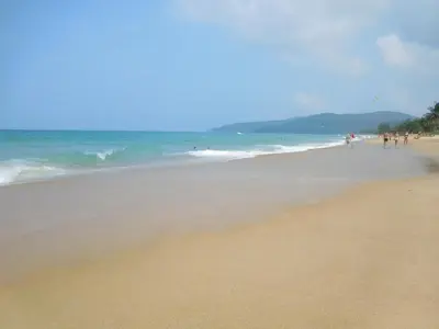 a group of people walking on the beach at Holiday Village And Natural Garden Resort in Karon Beach