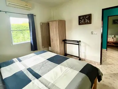 a bedroom with a bed and a window in it at 2 bedroom bungalow Nai Harn 4 Resort in Ban Suan