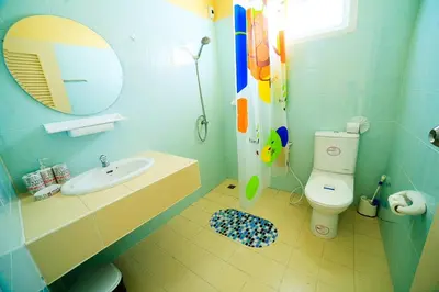 a bathroom with a sink and a toilet and a mirror at 2 bedroom bungalow Nai Harn 4 Resort in Ban Suan