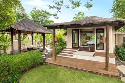 a wooden deck with a gazebo in a garden at The Naka Island, a Luxury Collection Resort & Spa, Phuket in Ko Naka