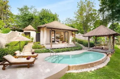 a backyard with a swimming pool and a villa at The Naka Island, a Luxury Collection Resort & Spa, Phuket in Ko Naka