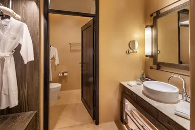 a bathroom with a sink and a toilet at The Naka Island, a Luxury Collection Resort & Spa, Phuket in Ko Naka