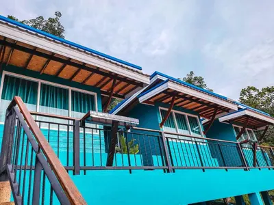 a blue house with a railing and a balcony at Ban Tidlay - SHA in Ko Yao Noi