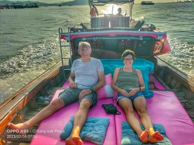 a man and woman sitting on alatable raft on a boat at Ban Tidlay - SHA in Ko Yao Noi