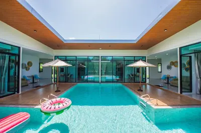 an indoor swimming pool with an inflatable pool toy at Good Night Pool Villa Phuket - SHA Plus in Phuket Town