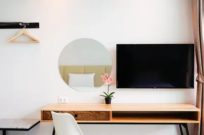 a desk with a tv and a mirror on a wall at Good Night Pool Villa Phuket - SHA Plus in Phuket Town