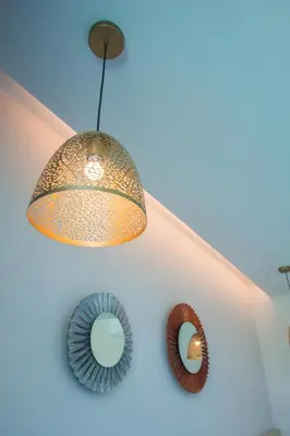 a chandelier and two mirrors on a wall at Good Night Pool Villa Phuket - SHA Plus in Phuket Town