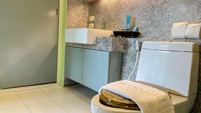 a bathroom with a white toilet and a counter at Great view in 81sqm top floor space in Kamala in Kamala Beach