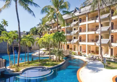 an aerial view of the resort with two pools and palm trees at Radisson Resort and Suites Phuket in Kamala Beach