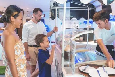 a group of people looking at a toy car at Radisson Resort and Suites Phuket in Kamala Beach