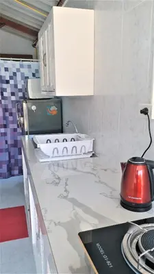a kitchen with a counter top with a tea kettle at Résidence Chez Nous Phuket in Rawai Beach