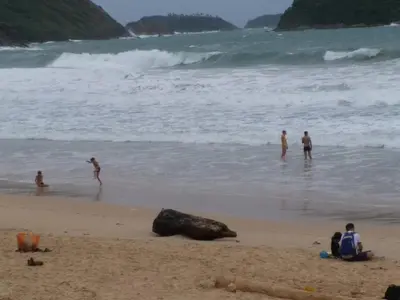 a group of people playing in the water at the beach at Résidence Chez Nous Phuket in Rawai Beach