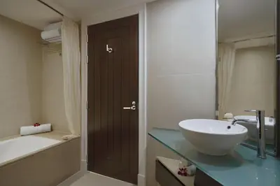 a bathroom with a sink and a tub and a toilet and a bath tub at Marriott's Mai Khao Resort - Phuket in Mai Khao Beach