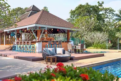 a gazebo next to a pool at a resort at Marriott's Mai Khao Resort - Phuket in Mai Khao Beach