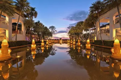 a canal in front of a building with palm trees at Marriott's Phuket Beach Club in Mai Khao Beach