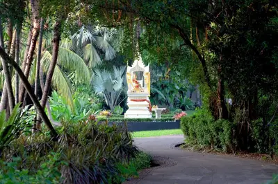 a statue in the middle of a park with trees at Marriott's Phuket Beach Club in Mai Khao Beach