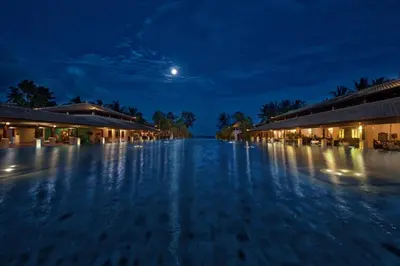 a view of a swimming pool at night at Marriott's Phuket Beach Club in Mai Khao Beach