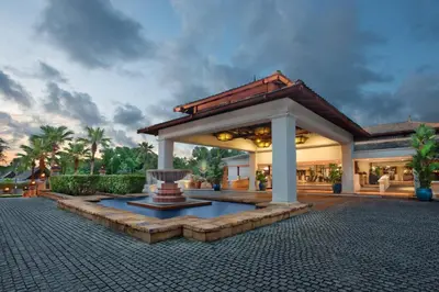 a building with a fountain in the middle of a courtyard at Marriott's Phuket Beach Club in Mai Khao Beach