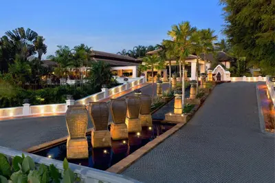 a row of chairs in the water at a resort at Marriott's Phuket Beach Club in Mai Khao Beach