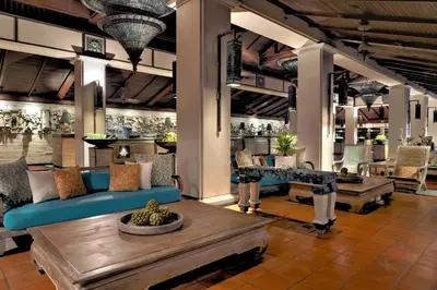 a lobby with a blue couch and a table at Marriott's Phuket Beach Club in Mai Khao Beach