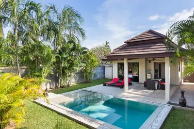 a backyard with a swimming pool and a house at Phuket Pool Residence - Adults only in Rawai Beach