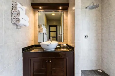 a bathroom with a sink and a mirror at Phuket Pool Residence - Adults only in Rawai Beach