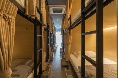 a row of bunk beds in a dorm room at Sleep Box Patong Hostel in Patong Beach