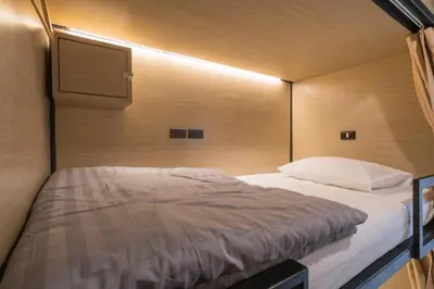 a bedroom with a large bed in a room at Sleep Box Patong Hostel in Patong Beach