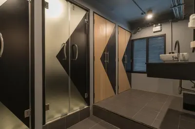 a bathroom with a shower and a sink at Sleep Box Patong Hostel in Patong Beach
