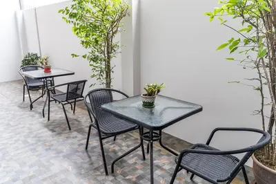a group of tables and chairs on a patio at Mr.T Kamala Room in Kamala Beach