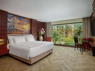 a bedroom with a large white bed and a large window at Novotel Phuket Vintage Park Resort in Patong Beach