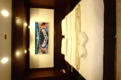 a hallway with two pictures on the walls of a room at Karon Cafe Inn in Karon Beach