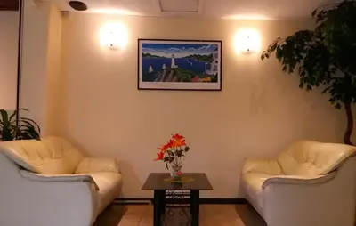 a waiting room with two couches and a table at Paradise Inn in Karon Beach