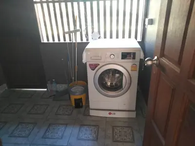 a washing machine with a dog inside of it at Bang Hon Homestay in Ko Yao Noi