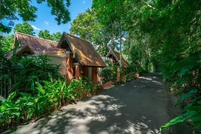 a house with a walkway next to a building at Suuko Villas in Chalong