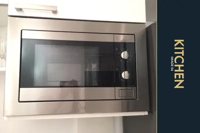 a stainless steel microwave oven in a kitchen at 3 BR Stylish Condo with Private Rooftop Pool in Kamala Beach