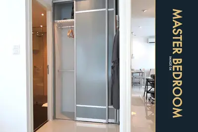 a glass wardrobe in a room with a table at 3 BR Stylish Condo with Private Rooftop Pool in Kamala Beach