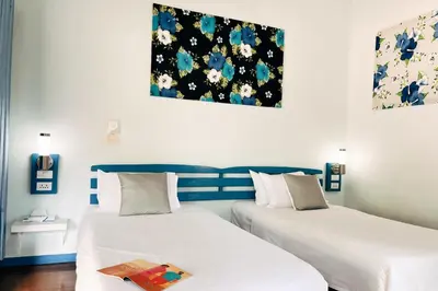 two beds in a room with white and blue at Cruiser Island By Swiss-Belhotel in Ko Lone